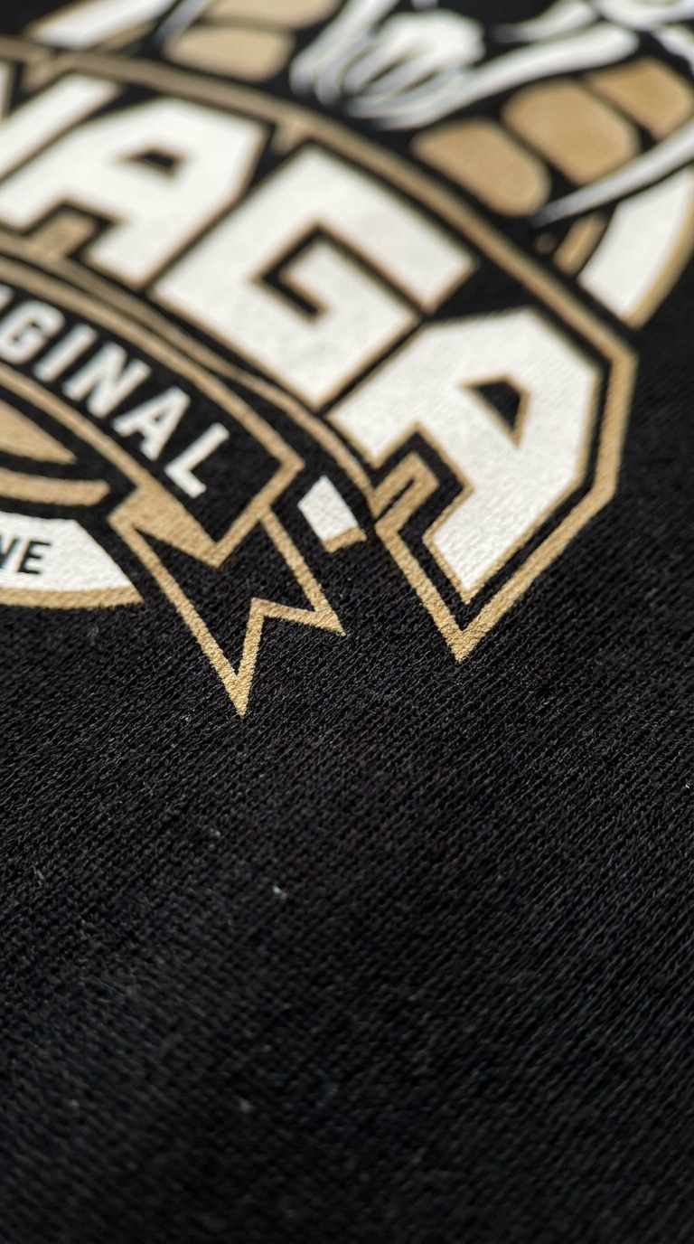 Close-up of the Naga Original cobra logo print on black cotton
